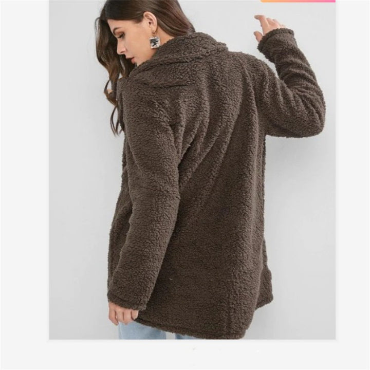 Woman wearing gray mid length loose coat with pockets