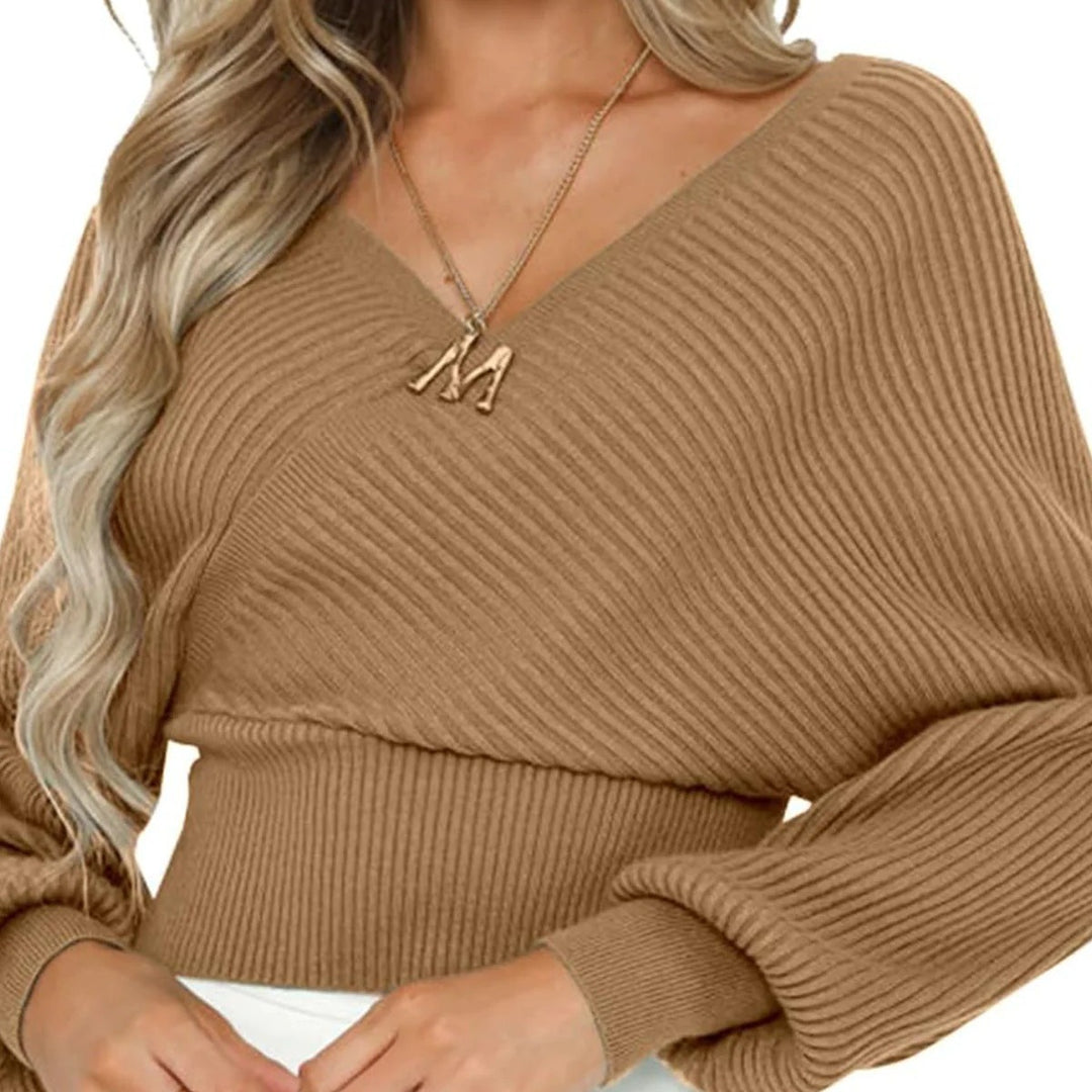 Woman wearing loose lantern sleeve sweater in apricot