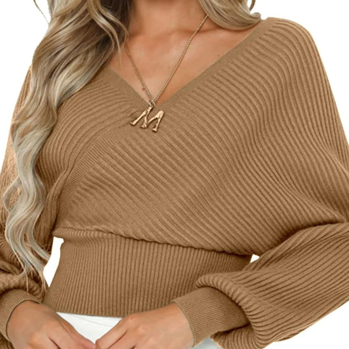Woman wearing loose lantern sleeve sweater in apricot