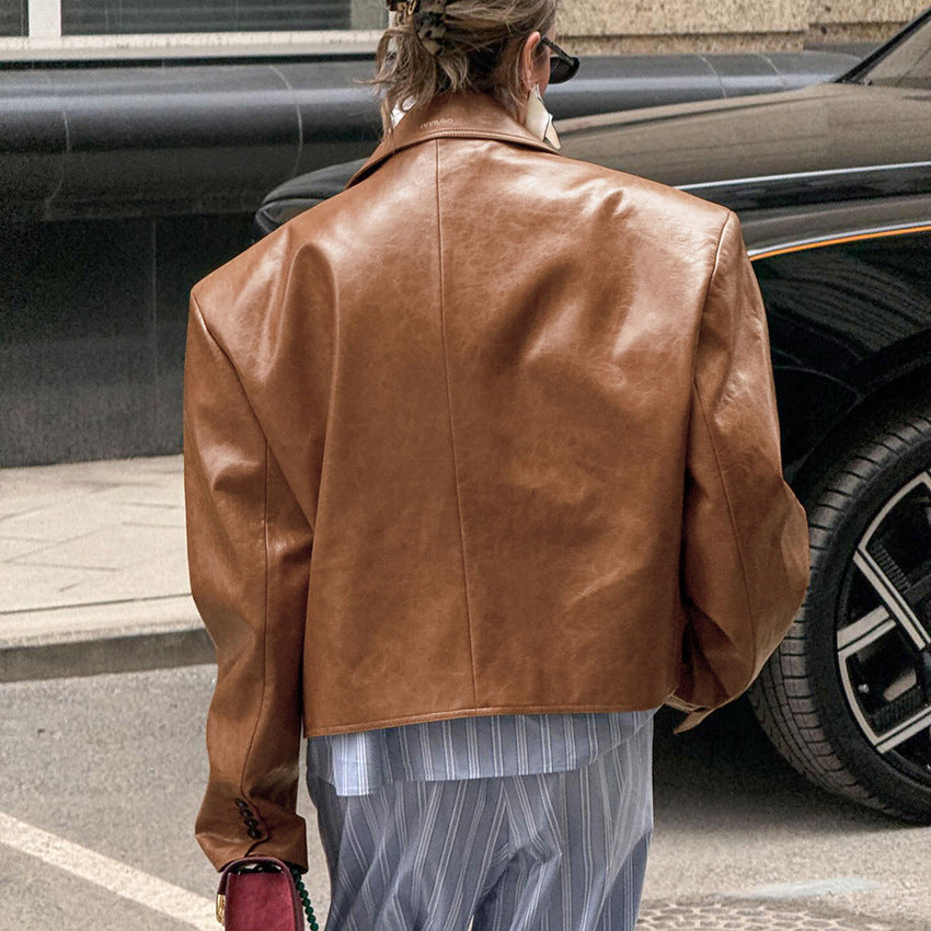Woman wearing brown suit collar faux leather jacket