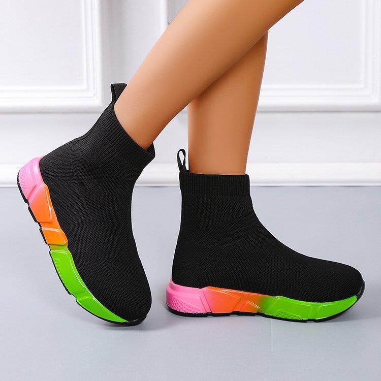 Woman wearing black and pink platform ankle boots