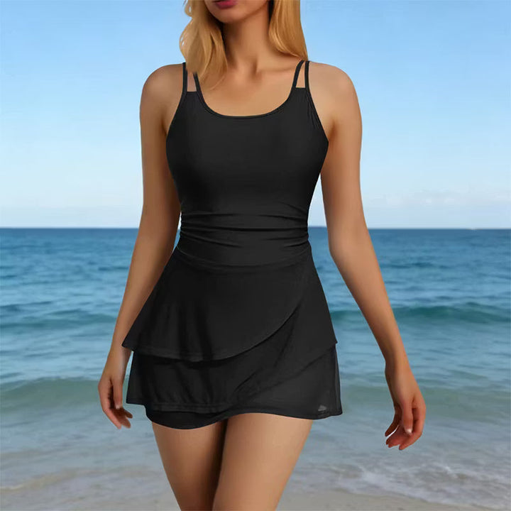 Woman wearing black sculpting two-strap swimsuit by the pool