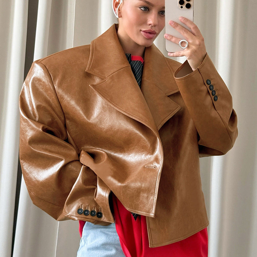 Woman wearing brown suit collar faux leather jacket