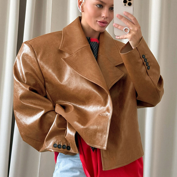 Woman wearing brown suit collar faux leather jacket