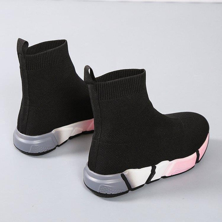 Woman wearing black and pink platform ankle boots