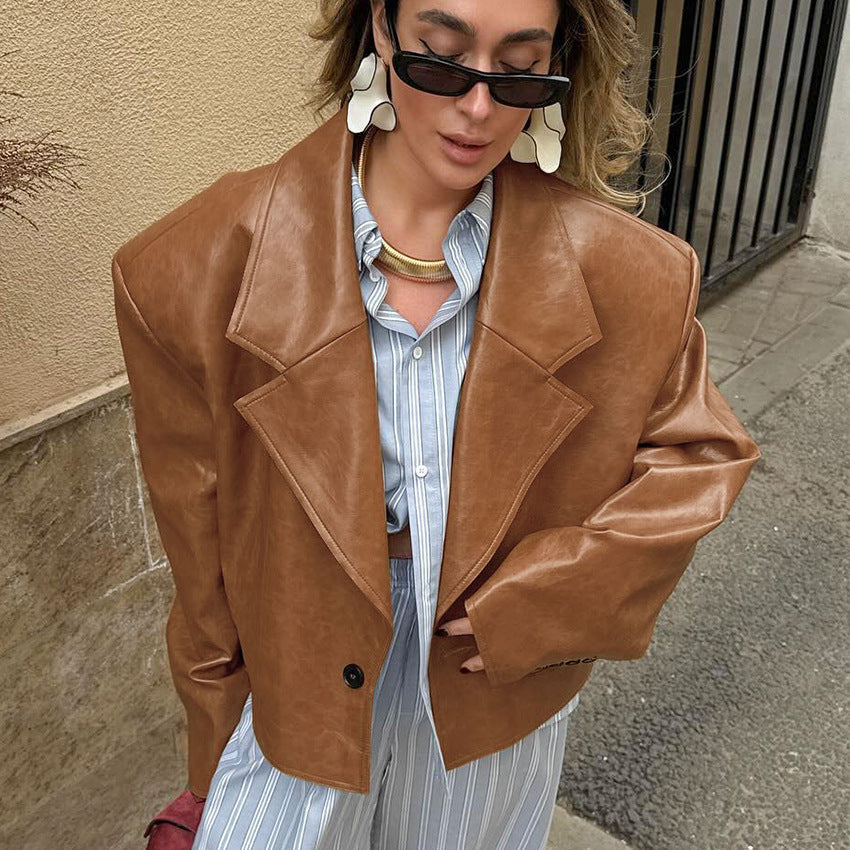 Woman wearing brown suit collar faux leather jacket