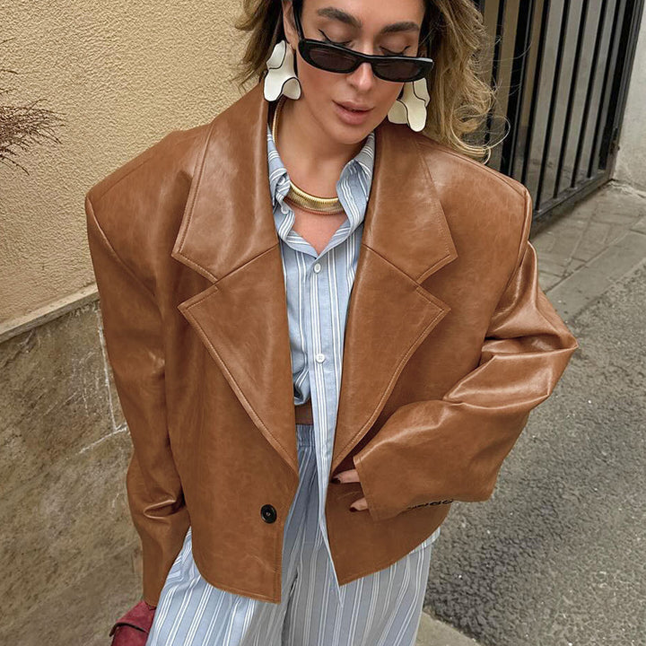 Woman wearing brown suit collar faux leather jacket