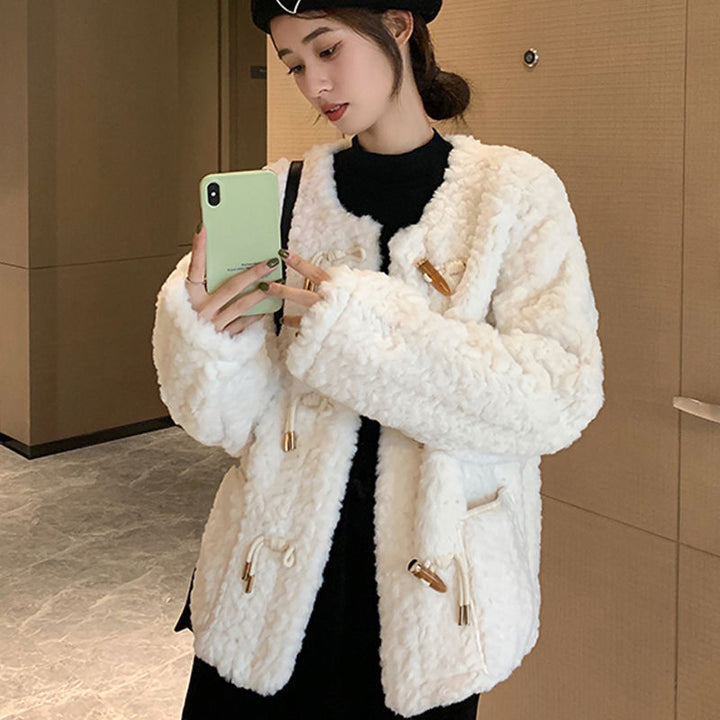 Woman wearing white short coat with long sleeves