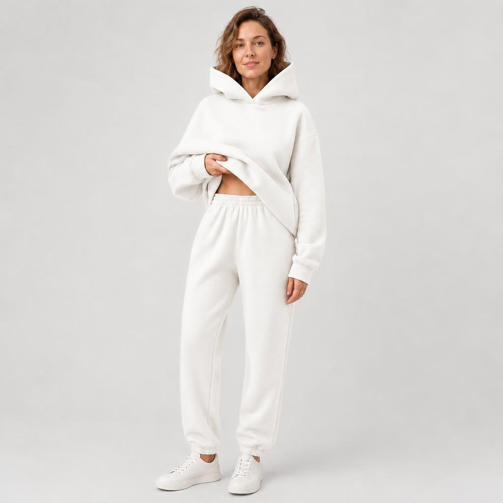 Woman wearing a hooded jogger set with elastic waist – white, worn by a model