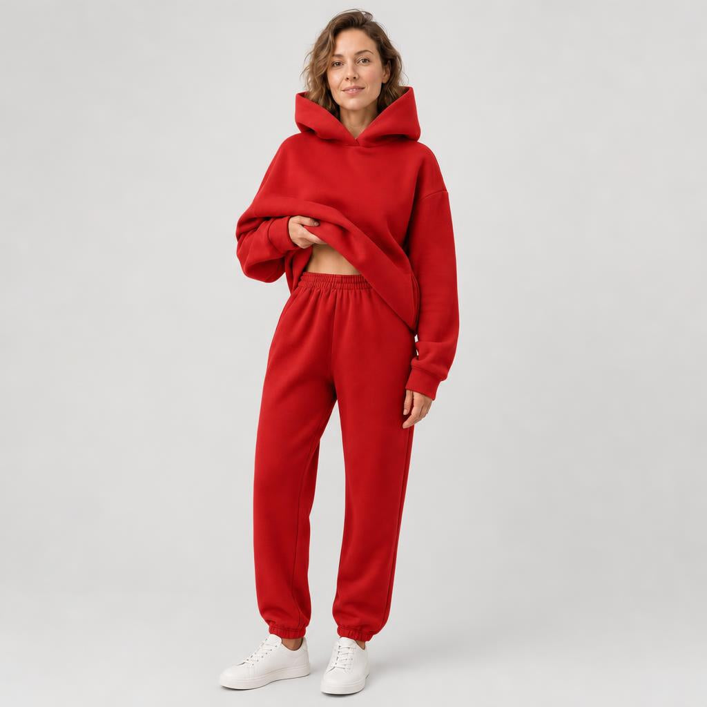 Woman wearing a hooded jogger set with elastic waist – red, worn by a model