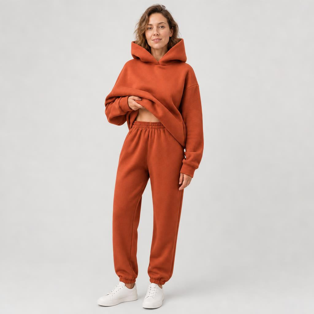 Woman wearing a hooded jogger set with elastic waist – rust, worn by a model