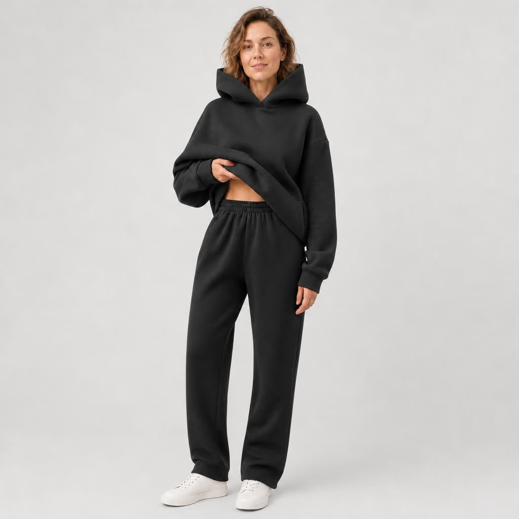 Woman wearing a hooded jogger set with elastic waist – black, worn by a model