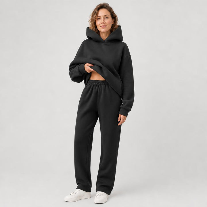 Woman wearing a hooded jogger set with elastic waist – black, worn by a model