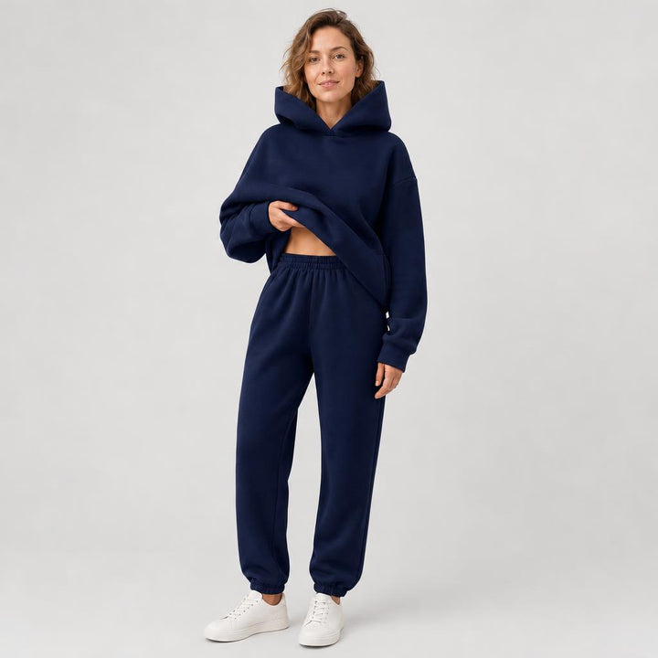 Woman wearing a hooded jogger set with elastic waist – navy blue, worn by a model