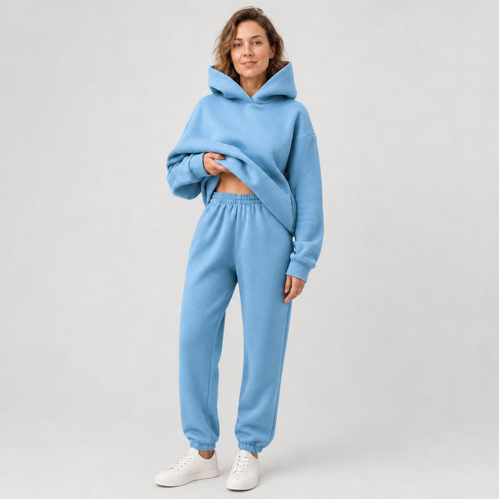 Woman wearing a hooded jogger set with elastic waist – blue, worn by a model