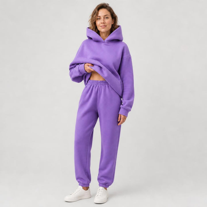 Woman wearing a hooded jogger set with elastic waist – purple, worn by a model