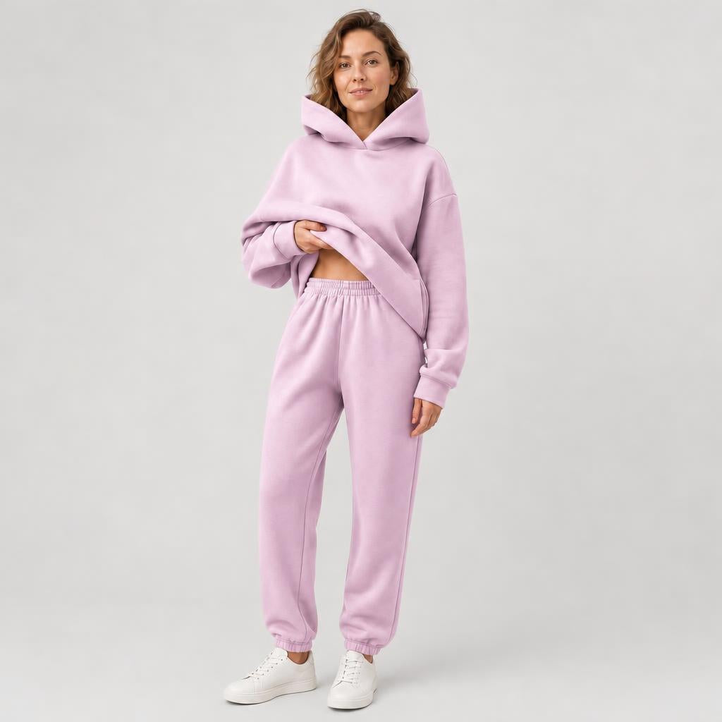 Woman wearing a hooded jogger set with elastic waist – pink, worn by a model