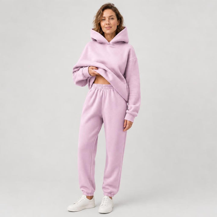 Woman wearing a hooded jogger set with elastic waist – pink, worn by a model