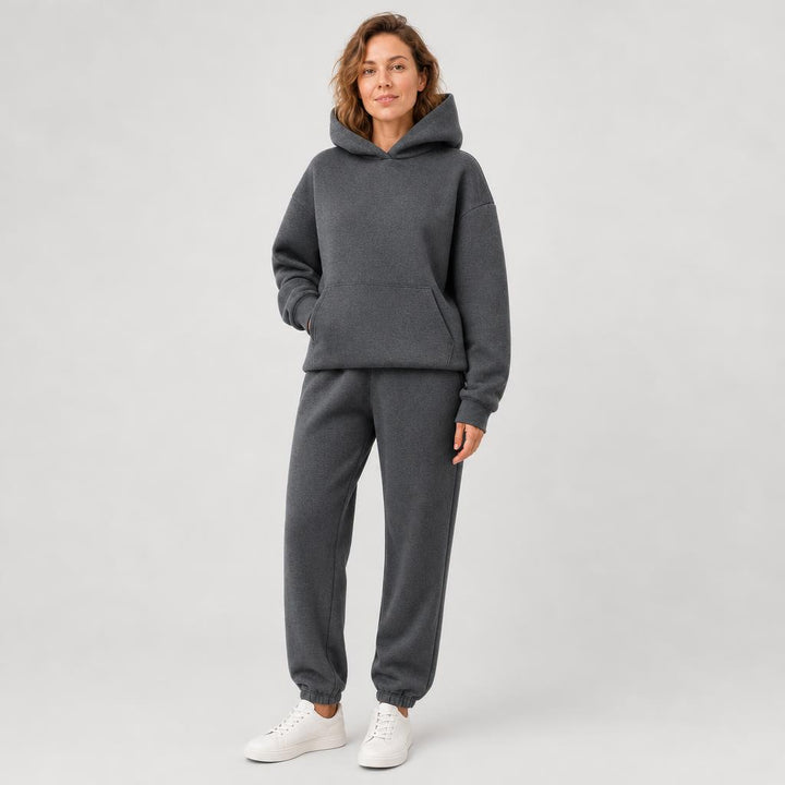 Woman wearing a hooded jogger set with elastic waist – dark gray, worn by a model