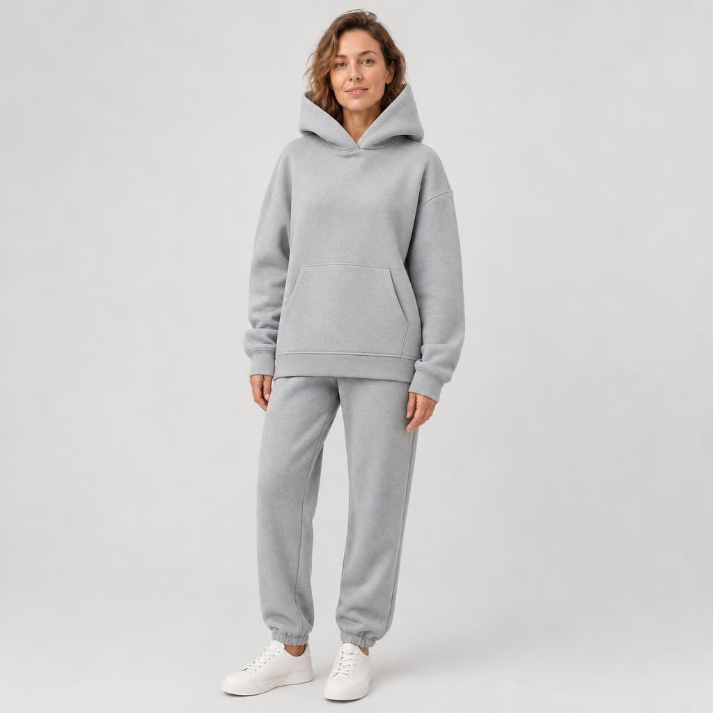 Woman wearing a hooded jogger set with elastic waist – light gray, worn by a model