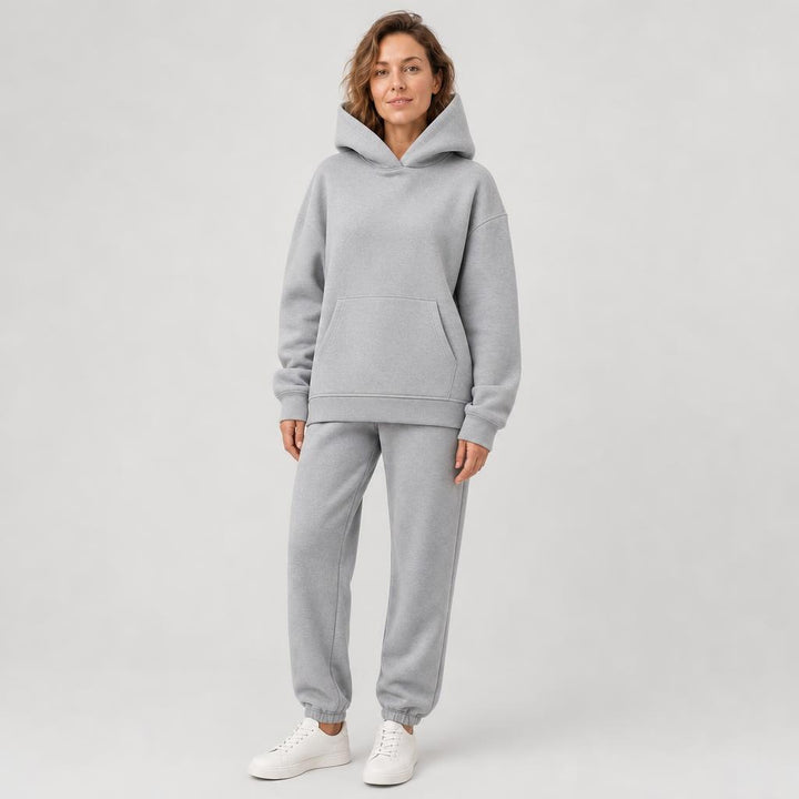 Woman wearing a hooded jogger set with elastic waist – light gray, worn by a model
