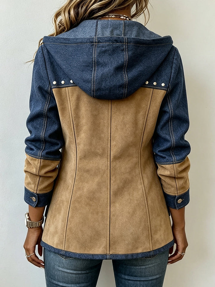 Woman wearing navy and camel hooded jacket with chest studs