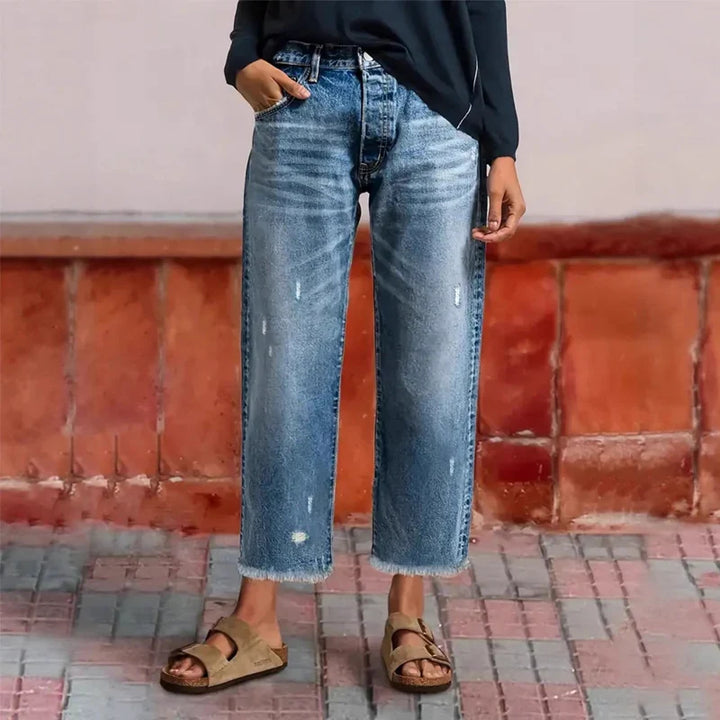 Woman wearing cropped straight leg jeans in blue