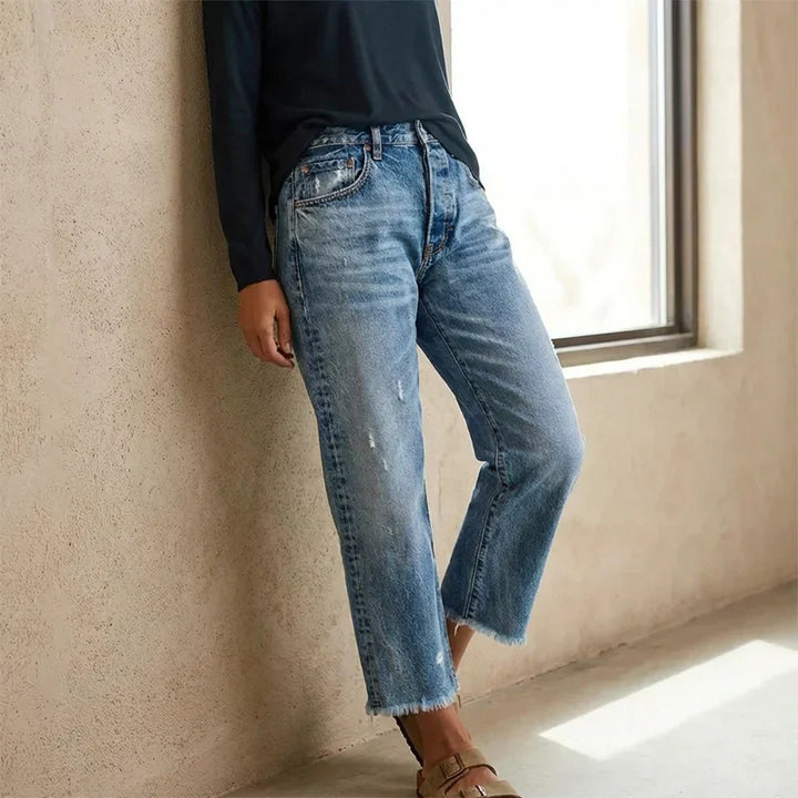 Woman wearing cropped straight leg jeans in blue
