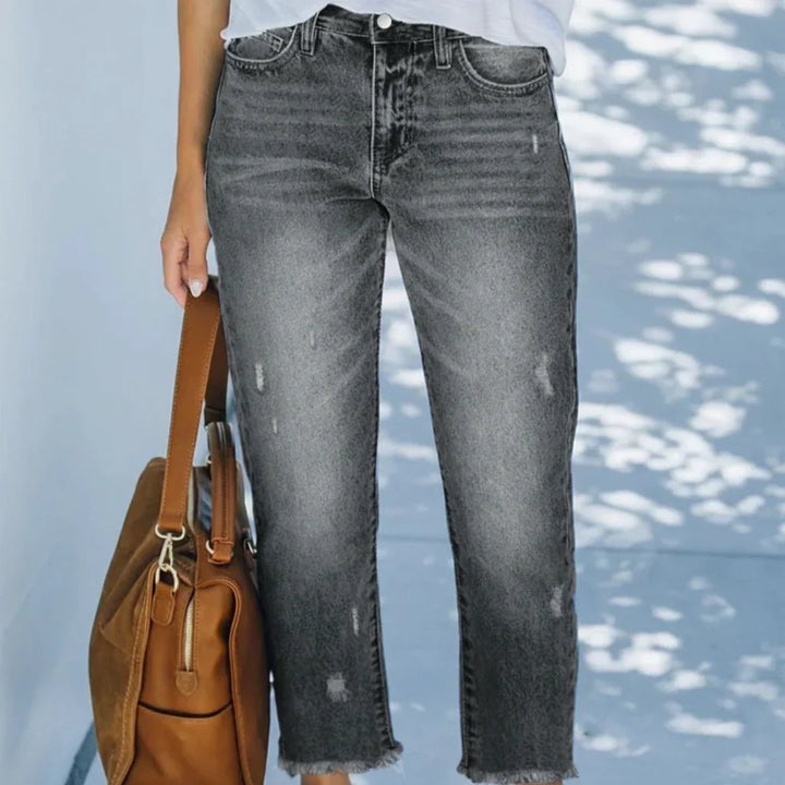 Woman wearing cropped straight leg jeans in blue